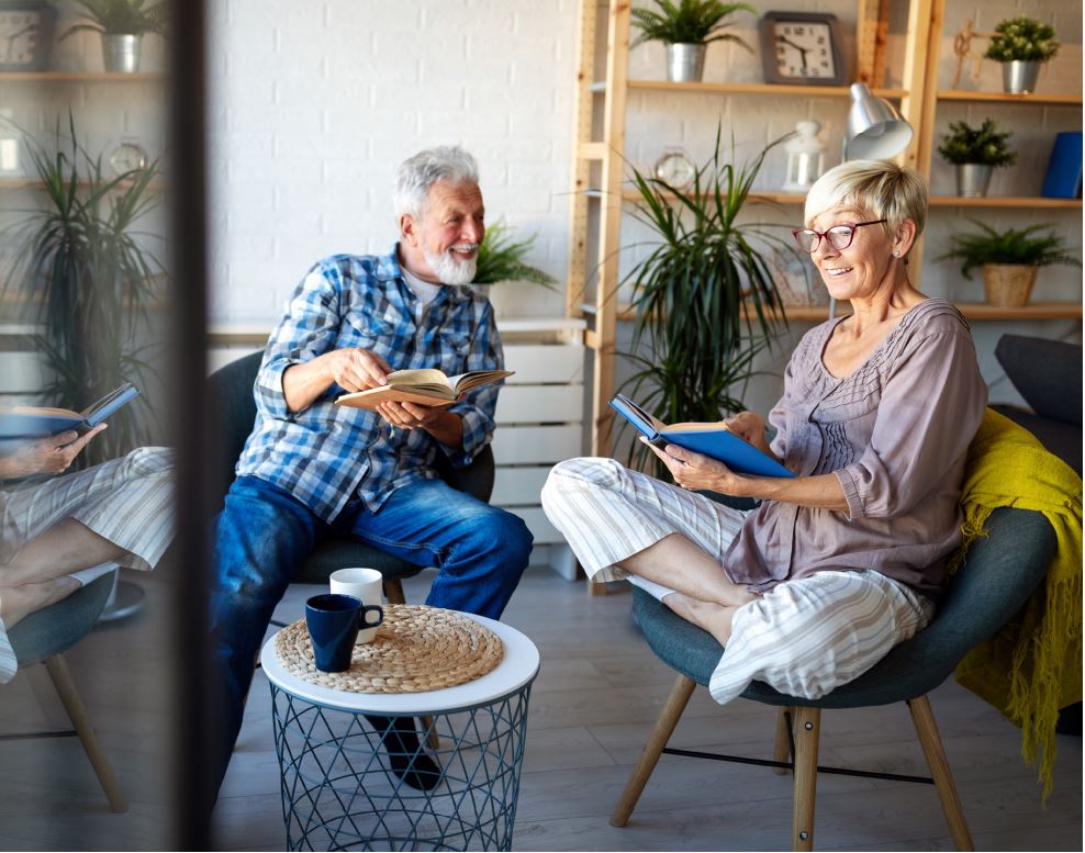 Retired couple reading books and chatting