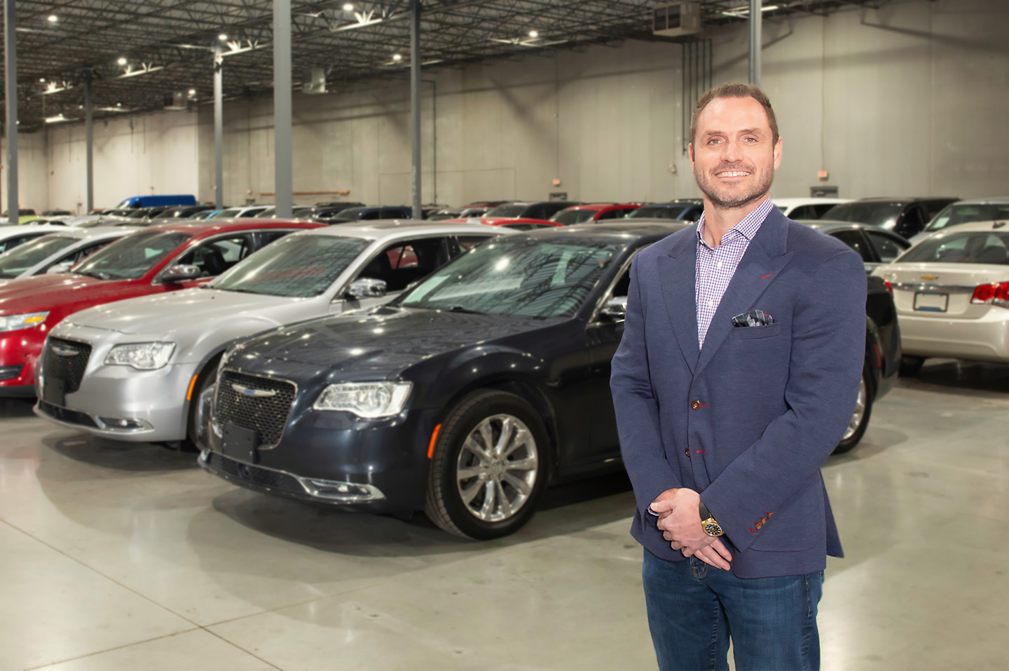 Ben Wheat standing in front of cars