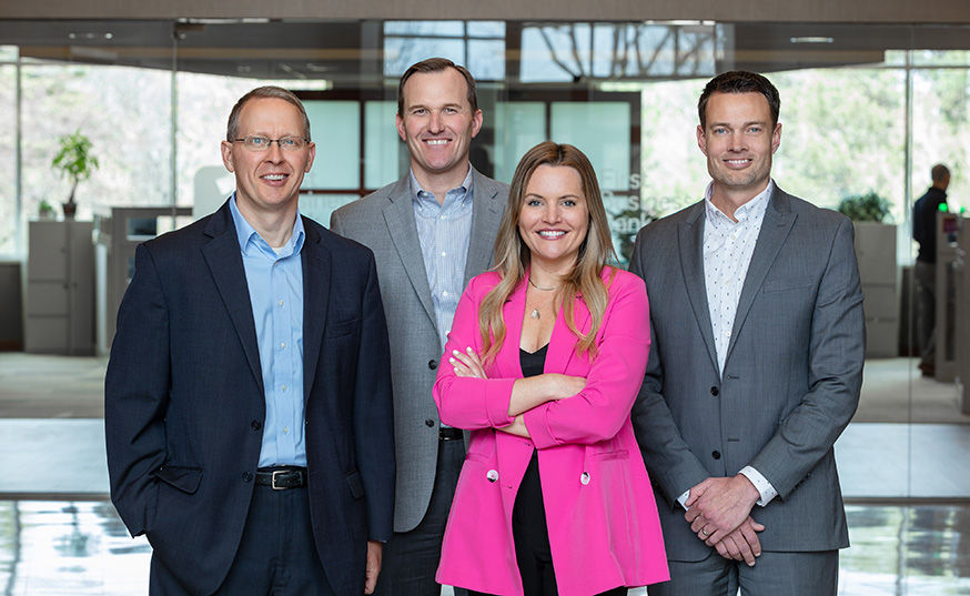 Brian Hagen, Josh Hoesch, Melissa Fellows, and Chris Doering standing side-by-side smiling at the camera