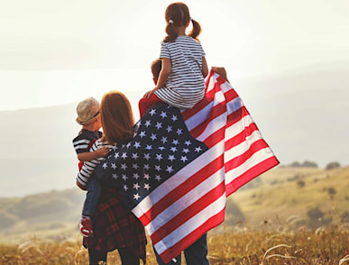 family carrying a flag